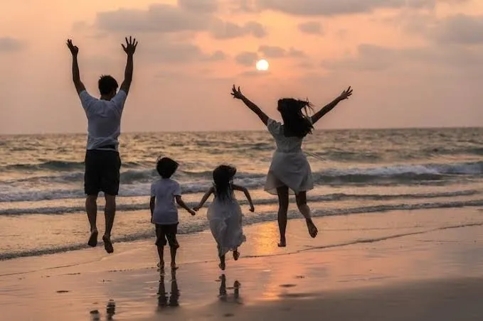 Family enjoying beach sunset